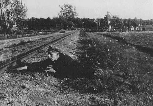 Jewish partisan Boris Yochai plants dynamite on railroad track Vilna 1943 or 1944